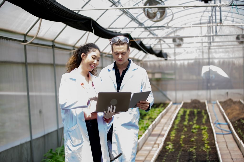 Organic Farmer Eco Agriculture researchers at smart organic farm. Innovative agricultural technology